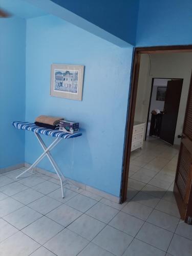 a table in a room with a blue wall at Patmay Greenery. Fresh air, vacation get away. in Saint-James