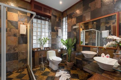 a bathroom with a toilet and a sink at Talay Naiharn Villa in Rawai Beach