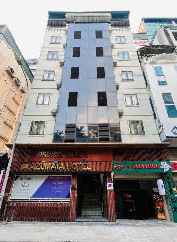 a tall building with an entrance to a store at Hotel Azumaya Linh Lang in Hanoi