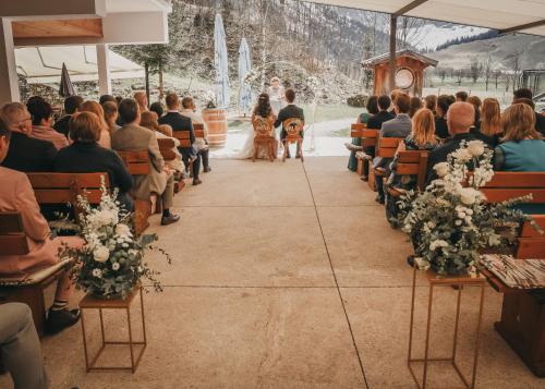 a bride and groom walking down the aisle at their wedding ceremony at Das Naturhotel die Eng in Hinterriss