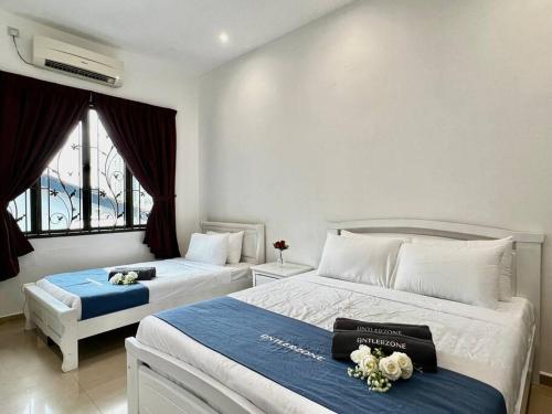 a bedroom with two beds and a window at Kim Teng Park, by Antlerzone in Johor Bahru