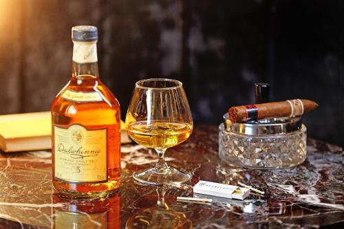 a bottle of white wine next to a glass at Negrecoste Hôtel & Spa in Aix-en-Provence