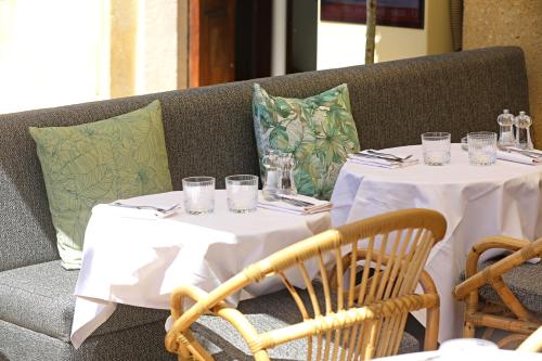 two tables with glasses on them on a couch at Negrecoste Hôtel & Spa in Aix-en-Provence
