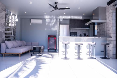 a kitchen and living room with a couch and a table at 海都-kaito- TOKYOBAY in Futtsu