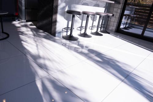 a shadow of stools on a counter in a restaurant at 海都-kaito- TOKYOBAY in Futtsu