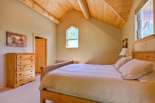 a bedroom with a bed and a dresser and a window at Morrisey Chalet at Sun Peaks in Sun Peaks