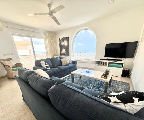 a living room with a couch and a tv at Villa Michael in St Paul's Bay