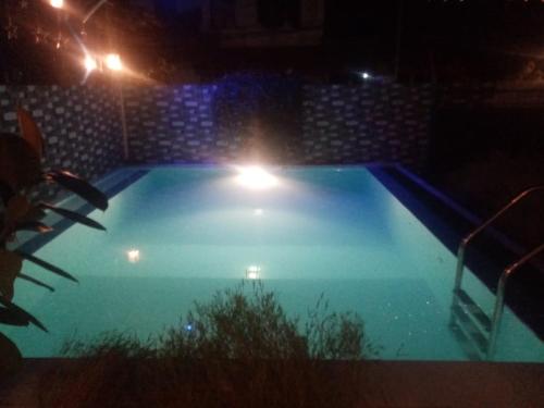 a swimming pool at night with lights in it at Andorra Tourist Resort Anuradhapura in Anuradhapura