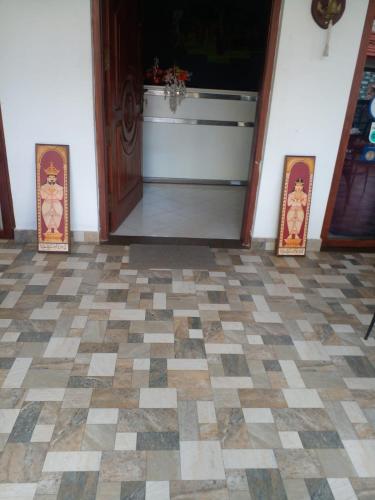 a room with a checkered floor and a door at Andorra Tourist Resort Anuradhapura in Anuradhapura