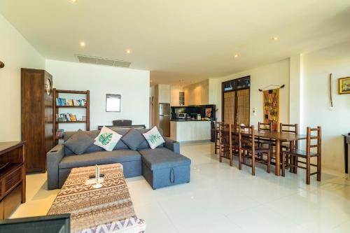 a living room with a couch and a table at Kamala Beach Estate Resort - SHA Extra Plus in Kamala Beach