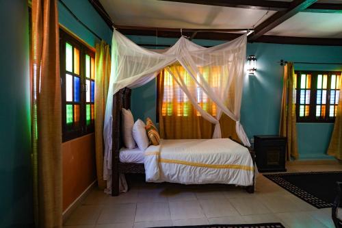 a bedroom with a bed with a canopy at Jafferji House in Zanzibar City