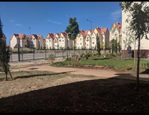 a row of houses in a park with a fence at Appartement Au jardin in Ifrane