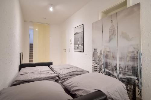 a bedroom with a bed with a picture on the wall at 5 Secret escape apartment above Stuttgart in Stuttgart
