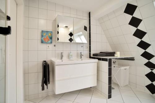 a white bathroom with a sink and a mirror at 5 Secret escape apartment above Stuttgart in Stuttgart