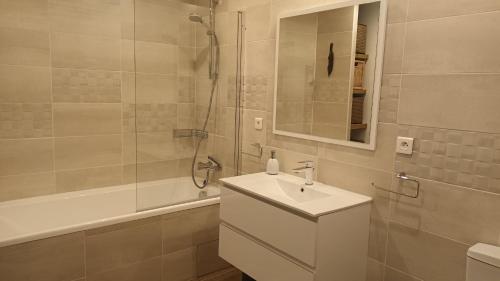 a white bathroom with a sink and a shower at Maison La Rascasse in Rayol-Canadel-sur-Mer