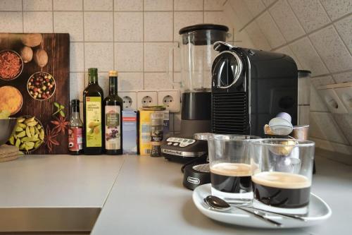 a kitchen counter with two cups of coffee on a counter top at 5 Secret escape apartment above Stuttgart in Stuttgart