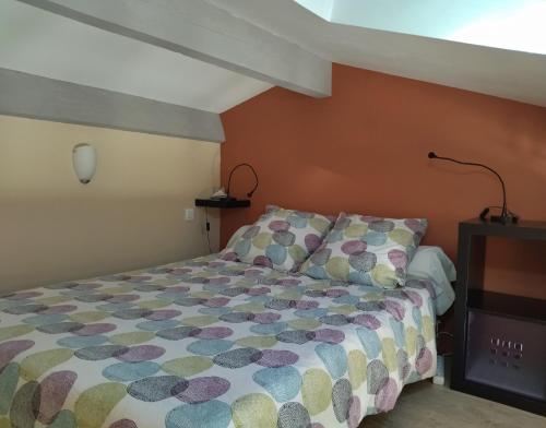 Dormitorio pequeño con cama y lámpara en Chambre d'hôtes Le Cocon, en Saint-Géniès-de-Malgoirès
