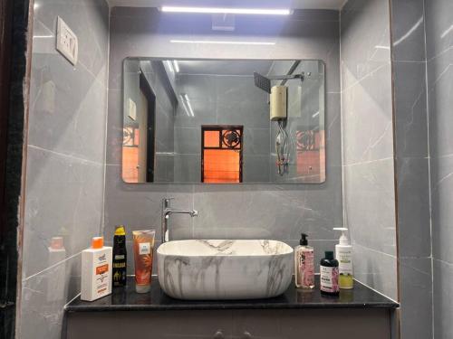 a bathroom with a sink and a mirror at Home Stay in Mumbai