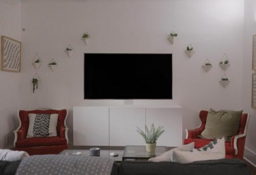 a living room with a flat screen tv on the wall at Clinton House in Lafayette