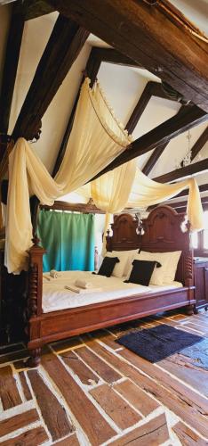a bedroom with a canopy bed in a room at Rustic Charm a Unique and Antique Apartment in Zagreb
