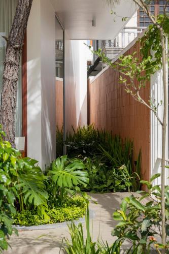 a courtyard with plants in front of a building at Nhãn Stay in Hue