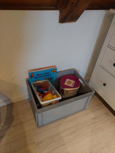a container filled with food on top of a kitchen floor at Altstadt Appartements in Landsberg am Lech