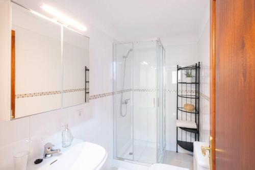 a white bathroom with a shower and a sink at Phoebe Apartment - city centre of Santa Cruz in Santa Cruz de la Palma