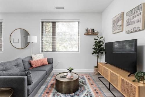 a living room with a couch and a tv at CozySuites Modern Studio in Meridian Kessler in Indianapolis