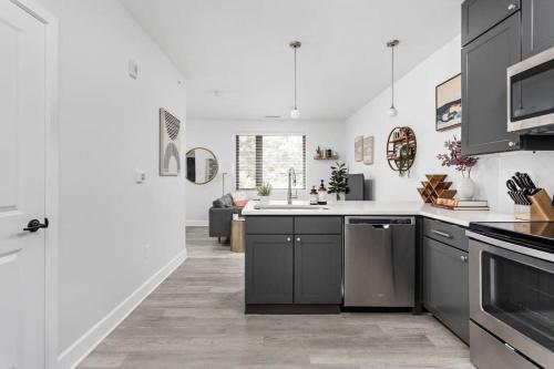 a kitchen with a sink and a stove top oven at CozySuites Modern Studio in Meridian Kessler in Indianapolis