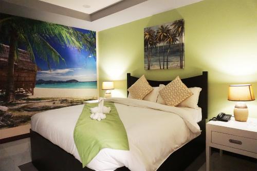 a bedroom with a bed and a painting on the wall at AMORE HOTEL MANILA in Manila