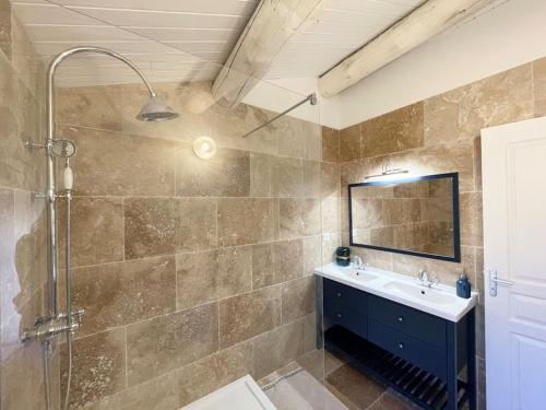 un bagno con lavandino, doccia e specchio di Maison l’Oustaou Cornillonnais a Cornillon-Confoux