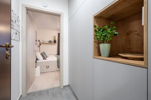 a hallway with a bathroom with a toilet and a sink at Heroes Square Apartment in Budapest