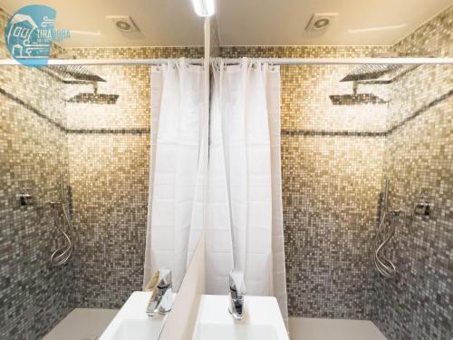 a bathroom with two sinks and a shower at Basovizza 3 Alessandro Tirabora Short Rent in Villa Opicina