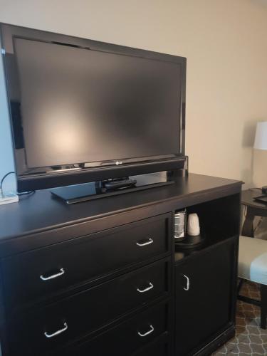 a black dresser with a flat screen tv on it at Natural Bridge Hotel, Trademark Collection by Wyndham in Natural Bridge
