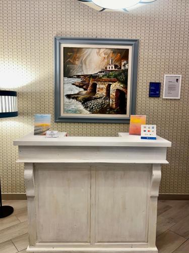 a picture frame on top of a counter in a room at B&B Vittoria in Anzio
