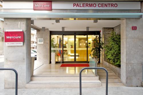 a entrance to a building with a sign on it at Mercure Palermo Centro in Palermo