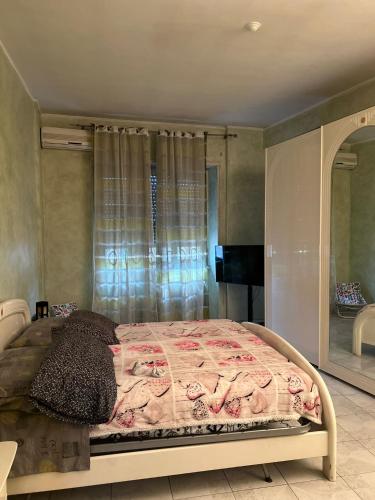 a bedroom with a large bed with a window at casa vacanza trastevere in Rome