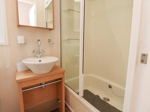 a bathroom with a sink and a shower at Larenzo in Preston