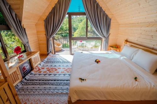 a bedroom with a bed with bugs on it at Bai Tu Long Mountain Resort in Hà Cái