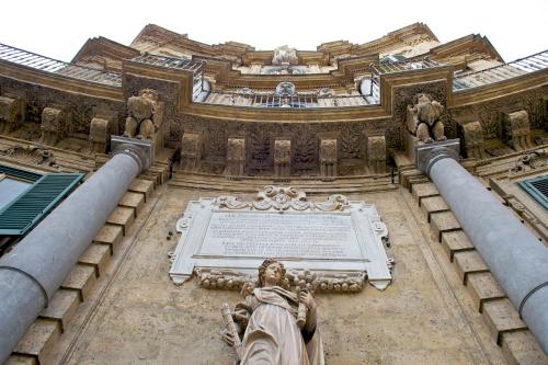 a statue on the side of a building at Mercure Palermo Centro in Palermo