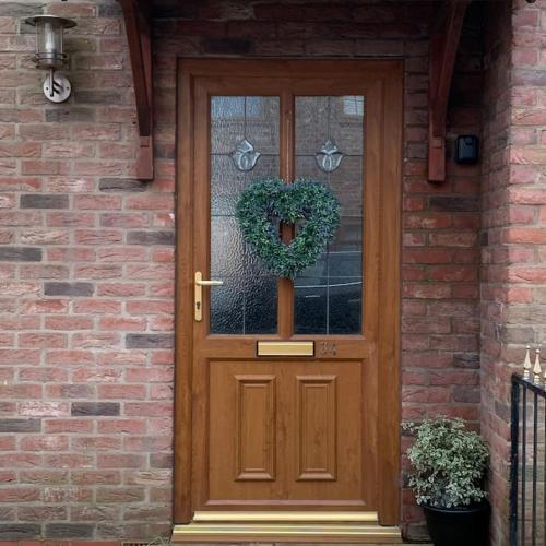 a wooden door with a wreath on a brick house at Ouse House in Swinefleet