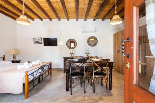 a bedroom with a bed and a table and chairs at Stone Court Boutique Studios in Paphos City