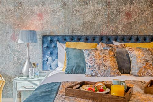 a bed with a tray of food on it at The Ley Arms in Exeter