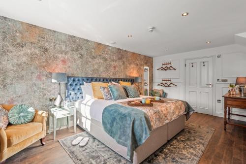 a bedroom with a bed and a desk and a chair at The Ley Arms in Exeter