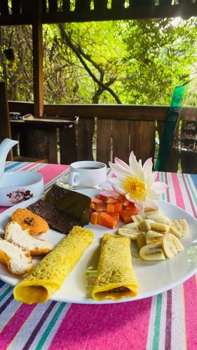 a white plate of food on a table at Hotel Hideaway Garage in Dambulla