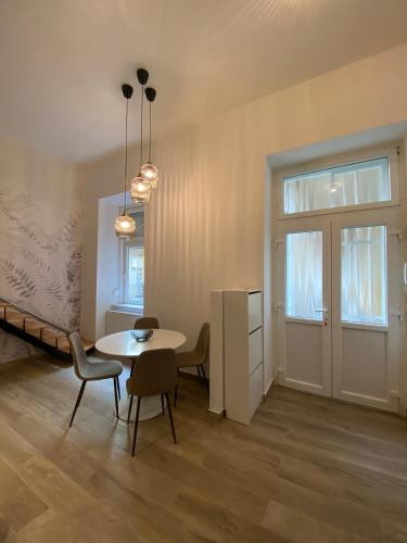 a dining room with a table and chairs in a room at Dembinszky utca in Budapest