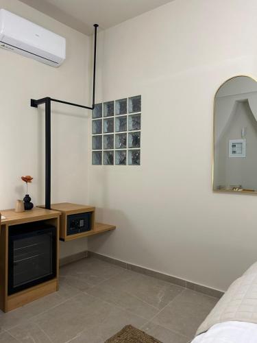 a bedroom with a bed and a mirror at Living Yard Acropolis in Athens