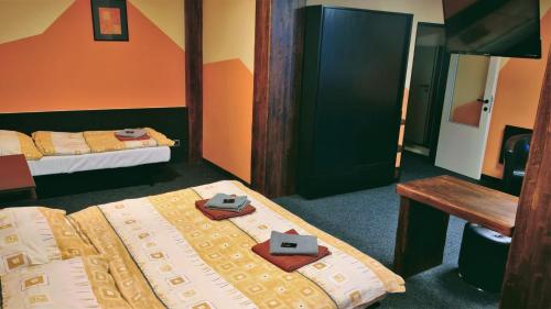 a hotel room with two beds with shoes on them at Sporthotel Bohemia in Rokytnice nad Jizerou