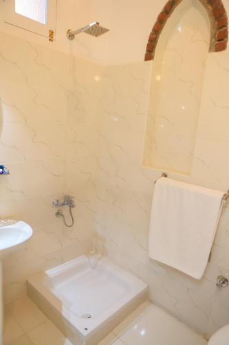 a bathroom with a white toilet and a sink at El Hanna Valley View in Luxor