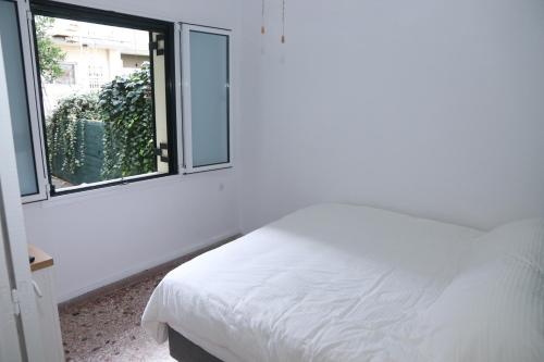 a bedroom with a white bed and a window at Magical villa western peloponnese by MPS in Pyrgos